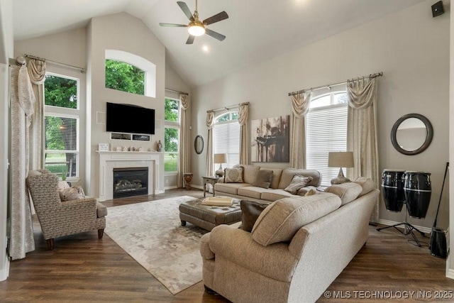 3401 N Narcissus Ave, Broken Arrow, OK 74012 - living room featuring high vaulted ceiling, ceiling fan, a glass covered fireplace, dark wood finished floors, and baseboards