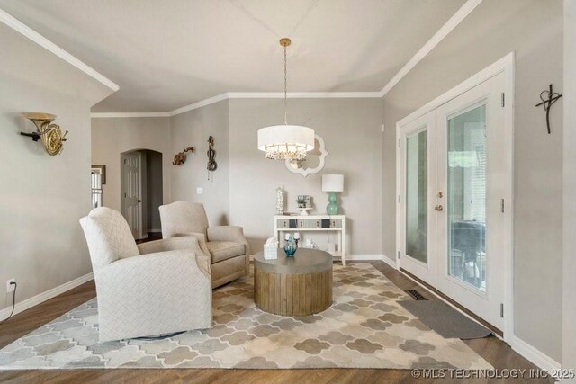 3401 N Narcissus Ave, Broken Arrow, OK 74012 - sitting room featuring wood finished floors, arched walkways, ornamental molding, baseboards, and a chandelier