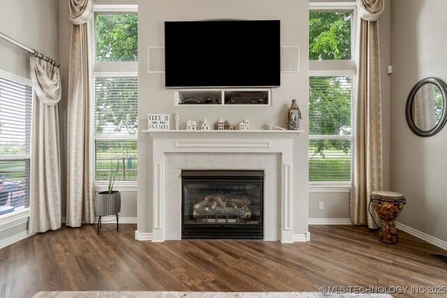3401 N Narcissus Ave, Broken Arrow, OK 74012 - detailed view of wood finished floors, baseboards, and a fireplace