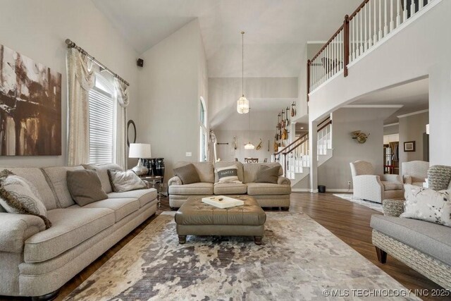 3401 N Narcissus Ave, Broken Arrow, OK 74012 - living area with arched walkways, wood finished floors, stairway, high vaulted ceiling, and baseboards