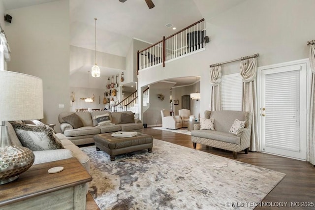 3401 N Narcissus Ave, Broken Arrow, OK 74012 - living area featuring arched walkways, high vaulted ceiling, ceiling fan, wood finished floors, and stairway