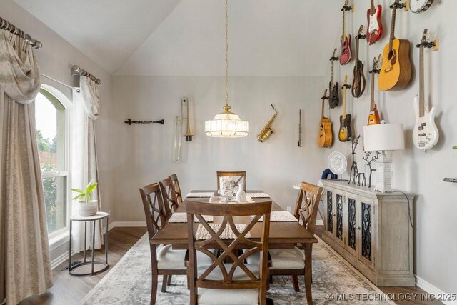 3401 N Narcissus Ave, Broken Arrow, OK 74012 - dining room with baseboards, light wood-type flooring, lofted ceiling, and a chandelier