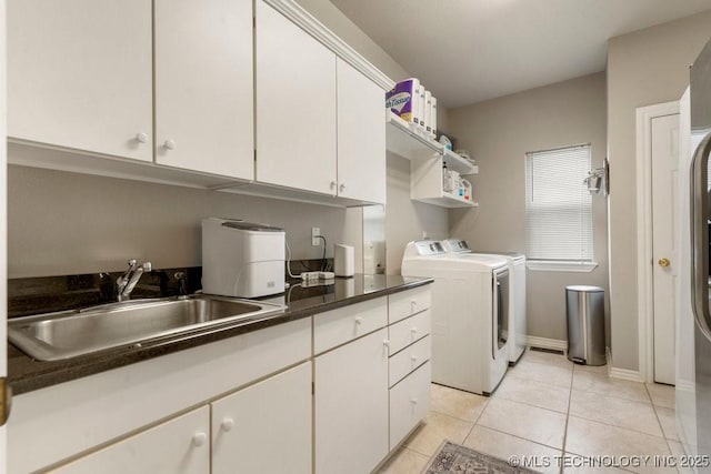 3401 N Narcissus Ave, Broken Arrow, OK 74012 - laundry area featuring independent washer and dryer, cabinet space, light tile patterned floors, and baseboards