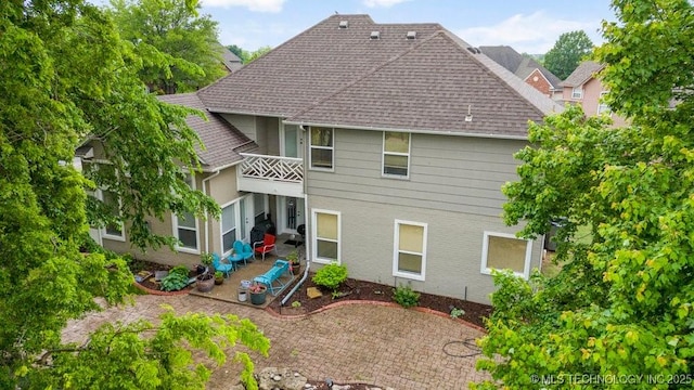 3401 N Narcissus Ave, Broken Arrow, OK 74012 - back of house with a balcony, roof with shingles, and a patio