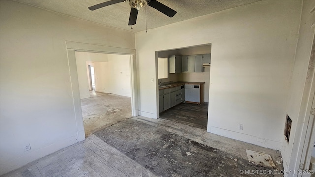 327 N G St, Muskogee, OK 74403 - empty room with baseboards, a textured ceiling, and ceiling fan
