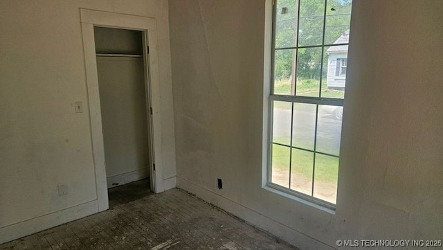 327 N G St, Muskogee, OK 74403 - unfurnished bedroom with baseboards and a closet