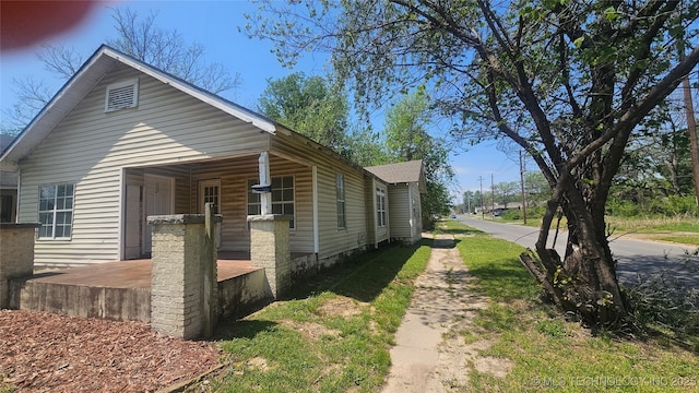 327 N G St, Muskogee, OK 74403 - view of side of property with a porch and driveway