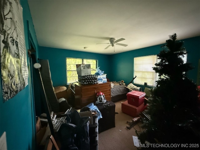carpeted bedroom featuring a ceiling fan and multiple windows