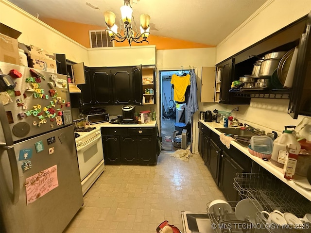 kitchen featuring visible vents, freestanding refrigerator, an inviting chandelier, brick patterned floor, and white range with gas cooktop
