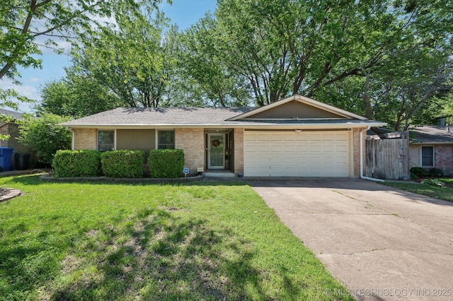 ranch-style house with concrete driveway, an attached garage, a front yard, and brick siding