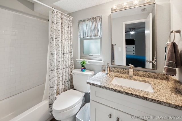 full bath with vanity, toilet, a textured ceiling, a ceiling fan, and shower / bath combo