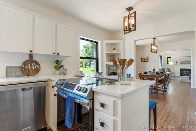 12415 N 75th E Ave, Collinsville, OK 74021 - kitchen featuring stainless steel appliances, a chandelier, white cabinets, decorative backsplash, and pendant lighting
