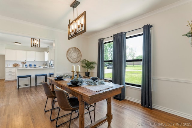 12415 N 75th E Ave, Collinsville, OK 74021 - dining area with a chandelier, ornamental molding, light wood-style floors, and healthy amount of natural light