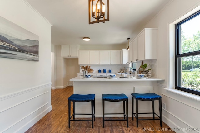 12415 N 75th E Ave, Collinsville, OK 74021 - kitchen featuring white cabinetry, a peninsula, light countertops, and a chandelier