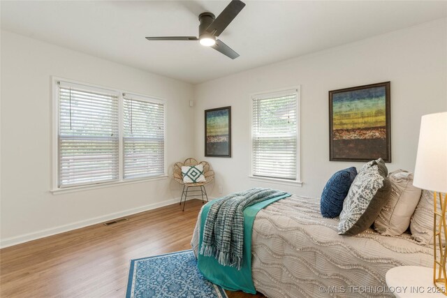 12415 N 75th E Ave, Collinsville, OK 74021 - bedroom featuring multiple windows, wood finished floors, and ceiling fan