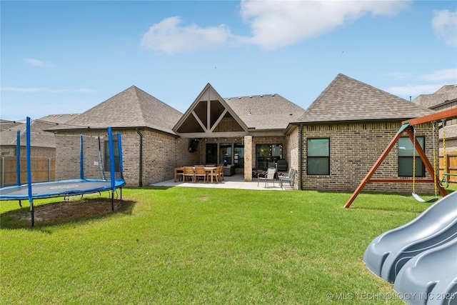 12509 S 102nd E Ave, Bixby, OK 74008 - rear view of house with fence, brick siding, a playground, a patio area, and a trampoline