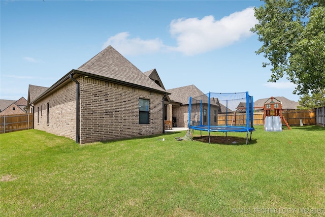 12509 S 102nd E Ave, Bixby, OK 74008 - view of yard with a fenced backyard and a trampoline