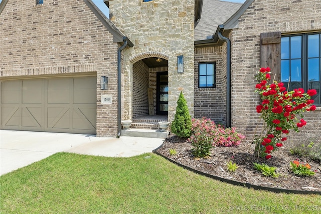 12509 S 102nd E Ave, Bixby, OK 74008 - doorway to property with brick siding, an attached garage, and driveway