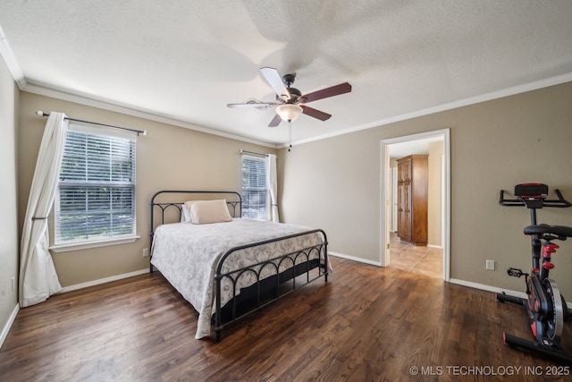 bedroom featuring crown molding, a textured ceiling, and multiple windows