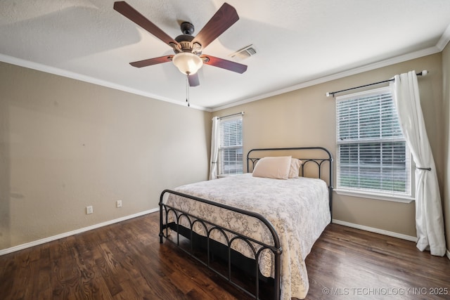 bedroom featuring a ceiling fan, baseboards, wood finished floors, visible vents, and ornamental molding