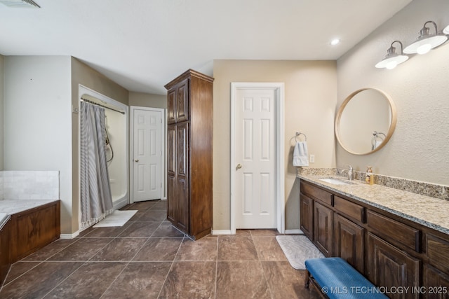 bathroom with vanity and baseboards