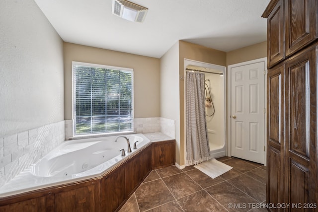 full bathroom featuring tile patterned floors, visible vents, a tub with jets, and curtained shower