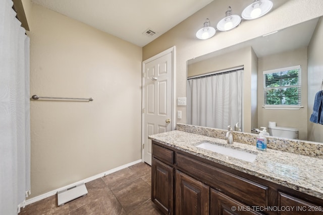 bathroom featuring visible vents, baseboards, toilet, and vanity
