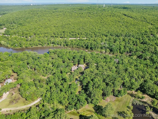 aerial view with a forest view and a water view