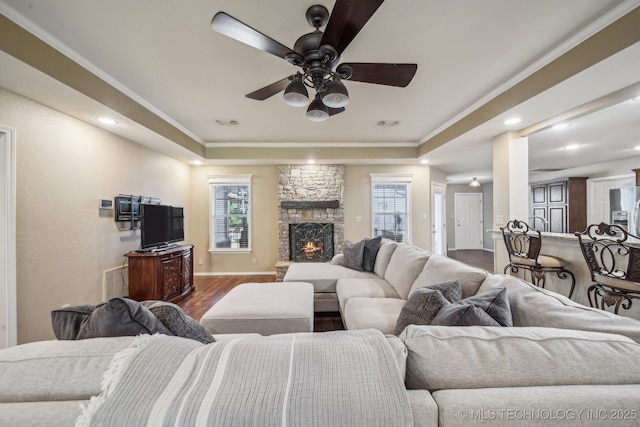 living area featuring visible vents, recessed lighting, a raised ceiling, a ceiling fan, and dark wood finished floors