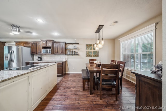 dining area with recessed lighting, baseboards, and dark wood finished floors