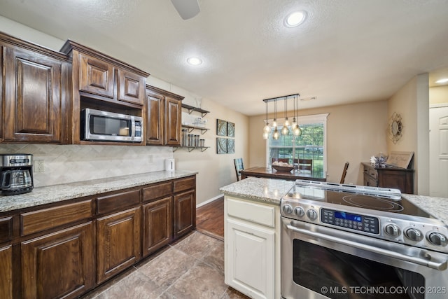 kitchen with pendant lighting, dark brown cabinetry, recessed lighting, tasteful backsplash, and appliances with stainless steel finishes