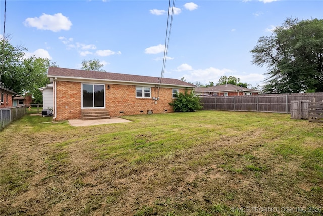 rear view of property with brick siding, entry steps, a fenced backyard, central air condition unit, and a yard