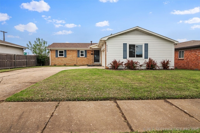 single story home featuring brick siding, fence, a front yard, and concrete driveway