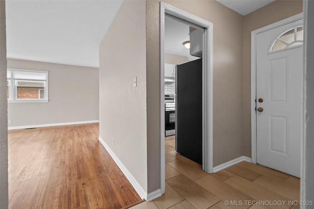 entrance foyer featuring baseboards and light wood-type flooring