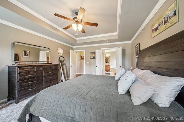 bedroom with baseboards, ornamental molding, ceiling fan, and a tray ceiling