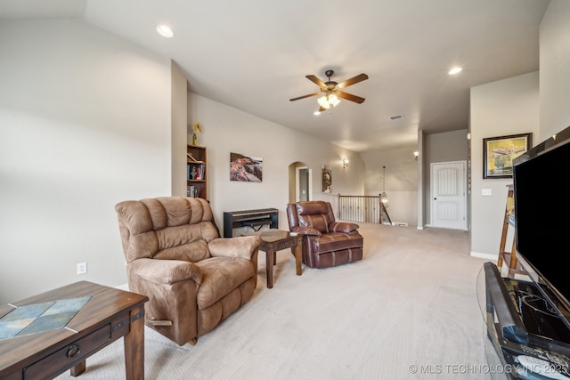 living area featuring arched walkways, ceiling fan, recessed lighting, and light carpet