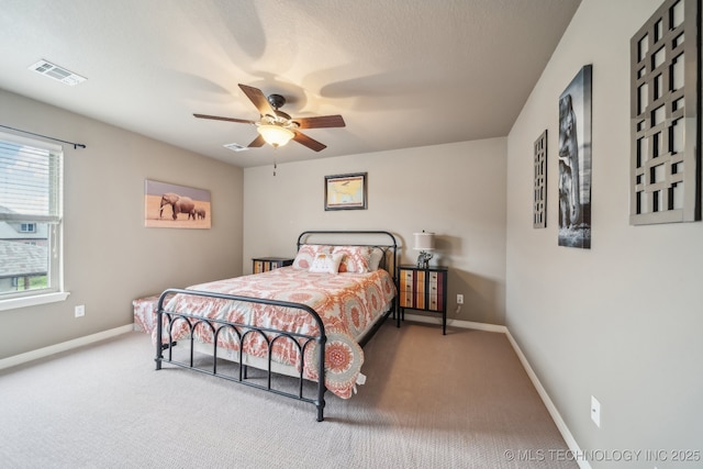 bedroom featuring carpet floors, baseboards, visible vents, and ceiling fan