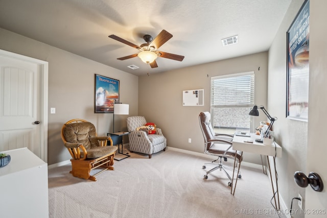 carpeted office space featuring visible vents, baseboards, and ceiling fan