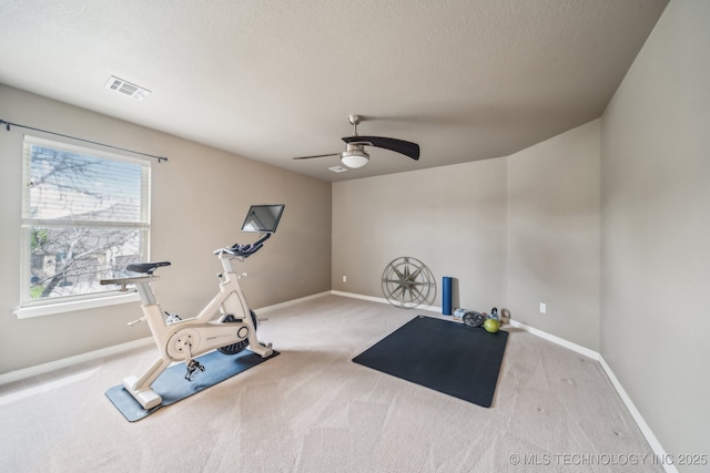 workout room with baseboards, ceiling fan, carpet, and visible vents