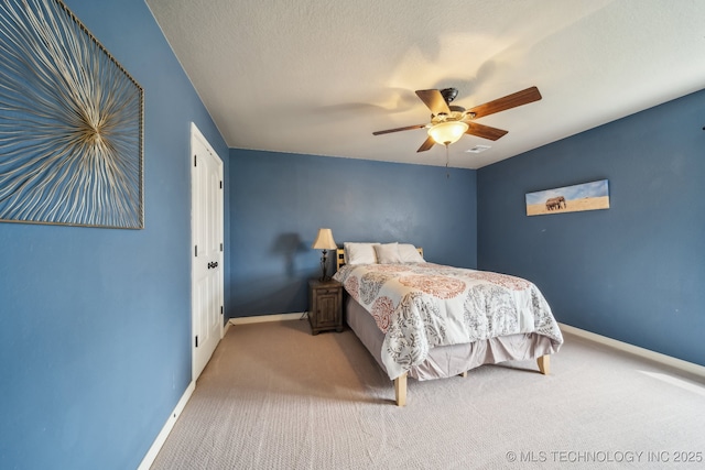 bedroom with carpet flooring, a ceiling fan, and baseboards