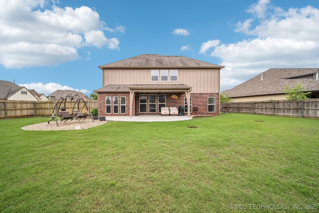 rear view of house with a patio, a fenced backyard, a lawn, and brick siding