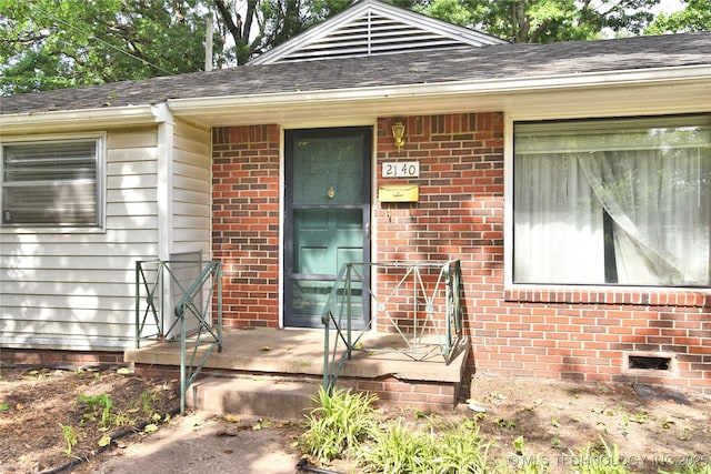 2140 S Columbia Ave, Tulsa, OK 74114 - doorway to property featuring brick siding and roof with shingles