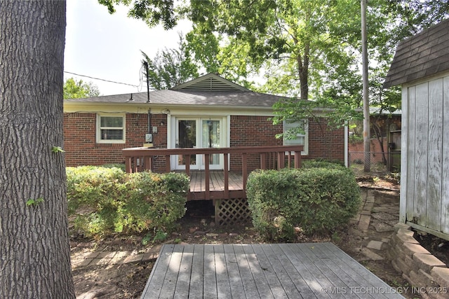 2140 S Columbia Ave, Tulsa, OK 74114 - rear view of property featuring brick siding, a wooden deck, and a shingled roof