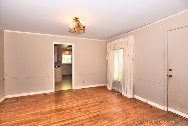 2140 S Columbia Ave, Tulsa, OK 74114 - spare room with crown molding, wood finished floors, baseboards, and a chandelier