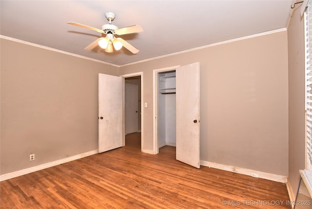 2140 S Columbia Ave, Tulsa, OK 74114 - unfurnished bedroom featuring crown molding, wood finished floors, baseboards, and a closet