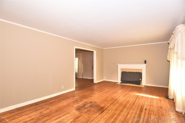 2140 S Columbia Ave, Tulsa, OK 74114 - unfurnished living room featuring light wood finished floors, baseboards, ornamental molding, and a fireplace with flush hearth