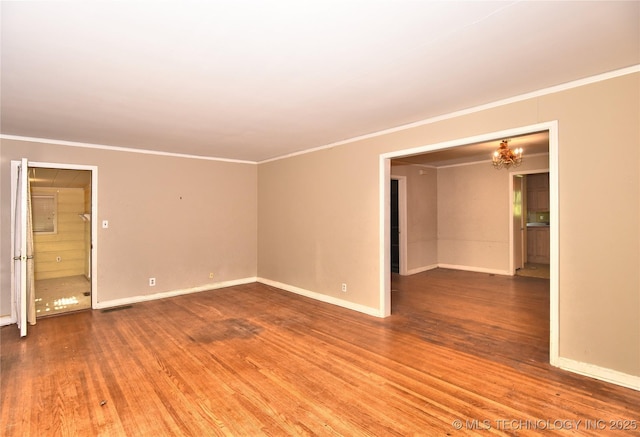 2140 S Columbia Ave, Tulsa, OK 74114 - spare room featuring crown molding, wood finished floors, a chandelier, and baseboards