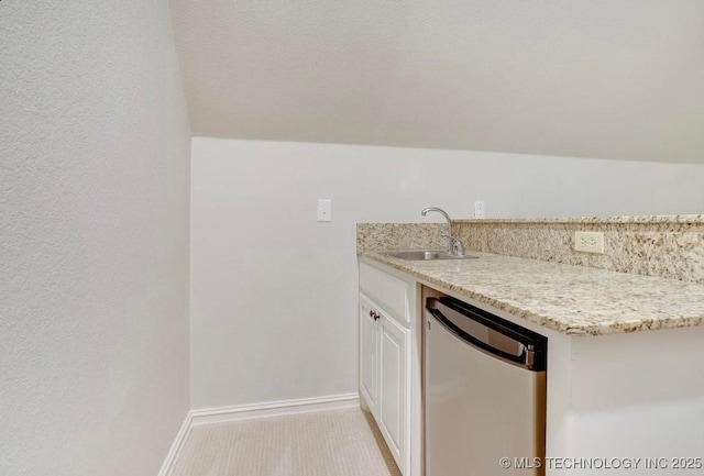 bar featuring baseboards, a sink, and dishwasher
