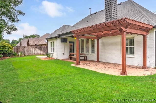 rear view of property featuring fence, a pergola, a chimney, and brick siding