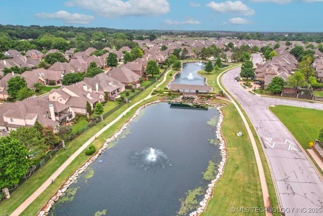 drone / aerial view with a residential view and a water view